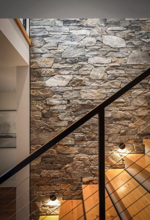 Stonework by Central Masonry | Home by Facet Builders | Photo by LSP Media Interior stone feature wall along a staircase, Ocean Mist mixed with Natural ledge stone by K2 Stone - Comox Valley BC