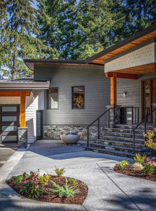 Stonework by Central Masonry | Home by Facet Builders | Photo by LSP Media Stone exterior facing, entry steps, and columns on a modern home in Courtenay BC, completed by Central Masonry