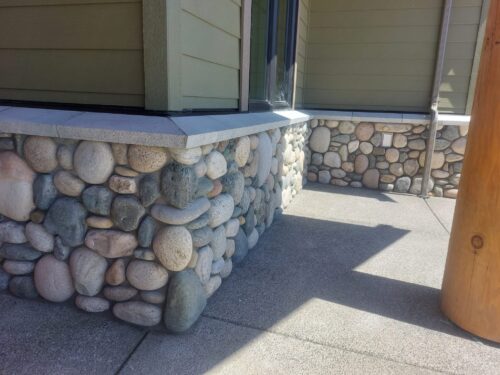 Full bed river rock stone exterior facing on home in Comox Valley BC